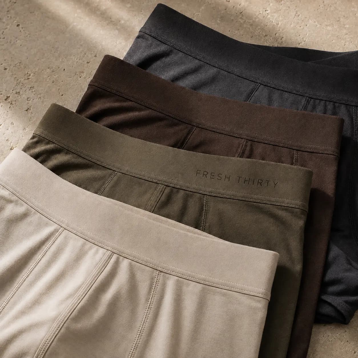 Four premium Fresh Thirty boxer briefs in charcoal, espresso, olive, and ivory